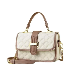 Quilted beige crossbody bag with brown trim and gold chain strap in 45-degree view