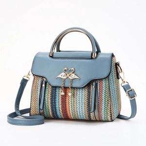 Colorful striped woven handbag with blue leather trim and golden swan tassel buckle