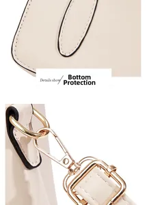 Close-up of beige leather bag stitching and light gold metal lobster clasp hardware