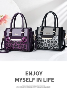 Detail of purple and grey leopard print patent leather handbags with gold metal hardware