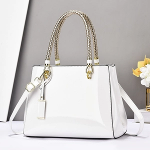 Elegant white patent leather handbag with gold woven handle and detachable shoulder strap