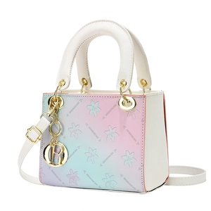 Floral gradient shoulder bag with dual top handles and metallic R pendant in 45-degree view