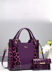 Detail of purple leopard print patent leather handbag with matching long wallet set