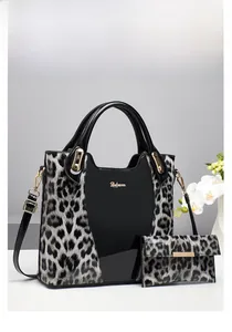 Detail of leopard print handbag set with gold hardware and elegant white orchid decor
