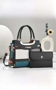 Detail of checkered handbag set with metallic handles and minimalist black wallet