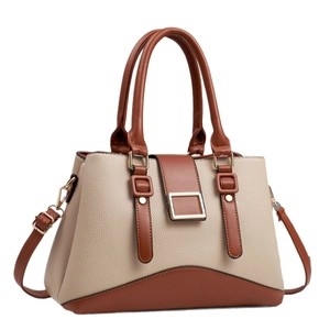 Women's two-tone pebbled leather handbag with gold buckle and adjustable strap