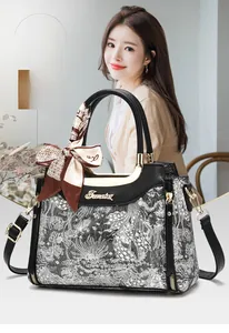 Macro detail of retro floral brocade handbag with leather trim and silk scarf