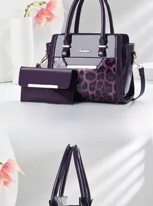 Detail of purple leopard print patent leather handbag set with gold hardware accents