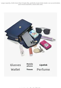 Flat lay showing the large capacity of a navy blue shoulder bag with multiple items