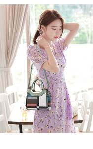 Detailed view of the multi-color patchwork leather handbag with metal hardware and handle