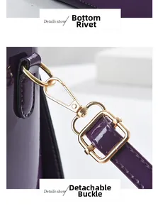 Close-up of purple glossy handbag showing golden bottom studs and detachable buckle detail