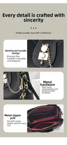 Detail of black lychee leather bucket bag with gold hardware and red fabric lining