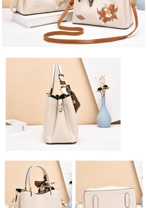 Close-up of floral embroidery detail and silk scarf handle on women shoulder bag