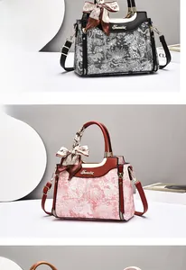 Close-up of floral tote bags with leather trim, silk scarves, and metallic buckles
