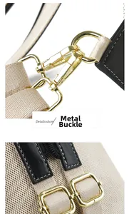 Detailed view of the gold hardware clasp and beige woven strap on a cartoon backpack