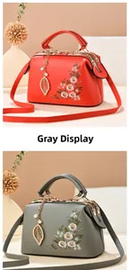 Detail of vintage flower embroidery on textured faux leather bags with pearl pendants