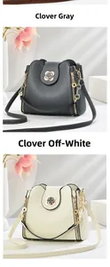 Detail view of lychee leather bucket bags with gold clover locks in grey and cream white