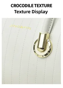 Macro view of white crocodile texture leather handbag with gold JING&PIN logo