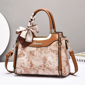 Retro brown embossed handbag with leather handle, gold zipper, and stylish silk scarf