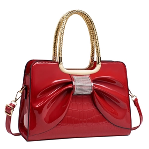 Red crocodile pattern handbag with large bow, glittery diamonds and golden metal handles