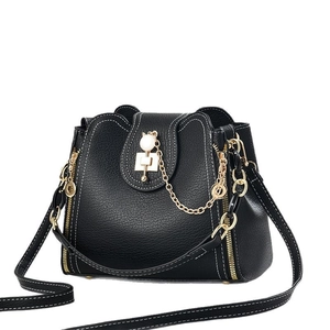 Black bucket bag with white contrast stitching, cat pearl charm and gold chain handle