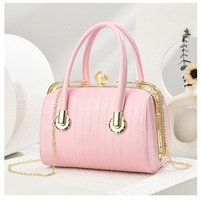 Pink handbag with pearl rhinestone buckle, gold chain strap and textured vertical stitching