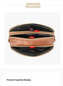 Detailed interior view of brown leather crossbody bag with multi-layer zipper compartments