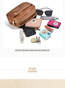 Brown faux leather crossbody bag showing multi-layered zipper opening and large storage capacity