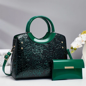 Dark green embossed floral handbag set with round handles and matching long wallet