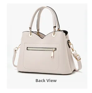 Detail view of the beige pebbled leather handbag back with zipper pocket and gold hardware