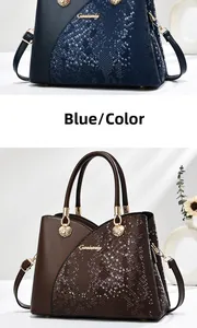 Detail of navy blue and brown bags with snakeskin texture and golden seashell accents