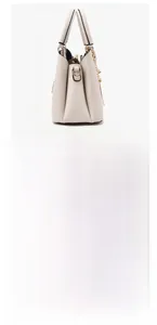 Detail view of beige lychee textured handbag side and bottom with golden protective feet