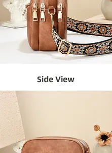 Detail view of brown textured leather bag with triple zippers and floral wide strap