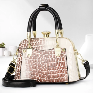 Detail of crocodile-embossed shell bag with beige-brown contrast and gold hardware