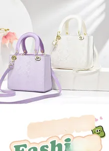Detail view of square animal-patterned handbags in purple and white with gold hardware