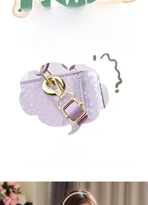 Detail of purple snake-texture handbag featuring premium gold metal hardware and charms