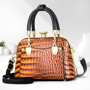 Brown crocodile embossed shell handbag with gold hardware and crystal clasp