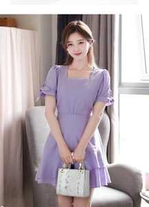 Close-up of lavender dress featuring square neck, puff sleeves and bow tie details