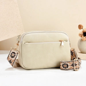 Chic beige multi-zipper crossbody bag with floral jacquard strap and gold hardware