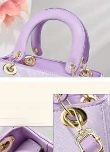 Close-up of golden hardware and lavender snake-pattern leather on the handbag