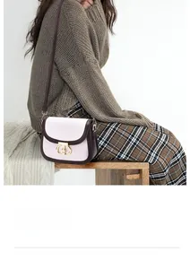 Detail of vintage beige woven crossbody bag with brown leather trim and metal lock