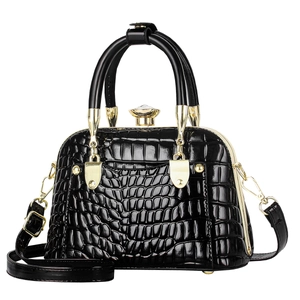 Glossy black shell bag with stone pattern, gold hardware and crystal clasp
