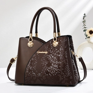 Deep brown crossbody tote featuring asymmetrical snakeskin texture and gold logo details