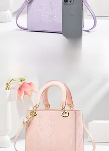 Close-up of pastel lavender faux snakeskin texture and golden ring hardware on mini bag