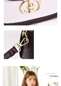 Detail view of gold-plated metal clasp and detachable strap hook on saddle bag