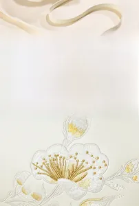 Detailed close-up of beige leather bag featuring exquisite floral embroidery with silk thread