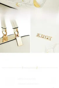 Close-up of white fabric handbag with floral embroidery and golden metal KUOY logo