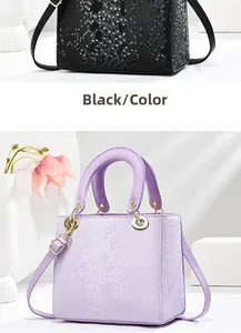 Detailed view of snake-embossed handbags in black and lilac with gold hardware accents