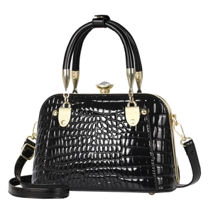 Glossy black shell bag with crocodile pattern, top handle and golden hardware on white background
