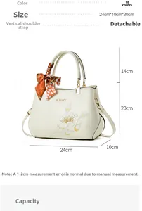 Detail view of cream handbag with floral embroidery and silk scarf handle decoration